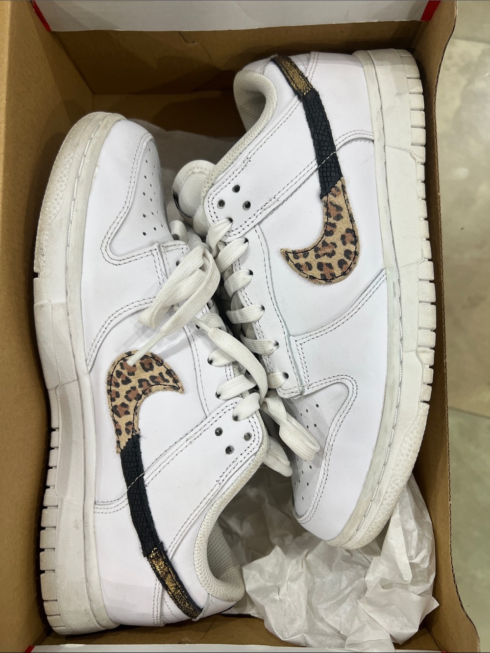 Nike White Kids Sneakers with Leopard Print Swoosh and Black Accent